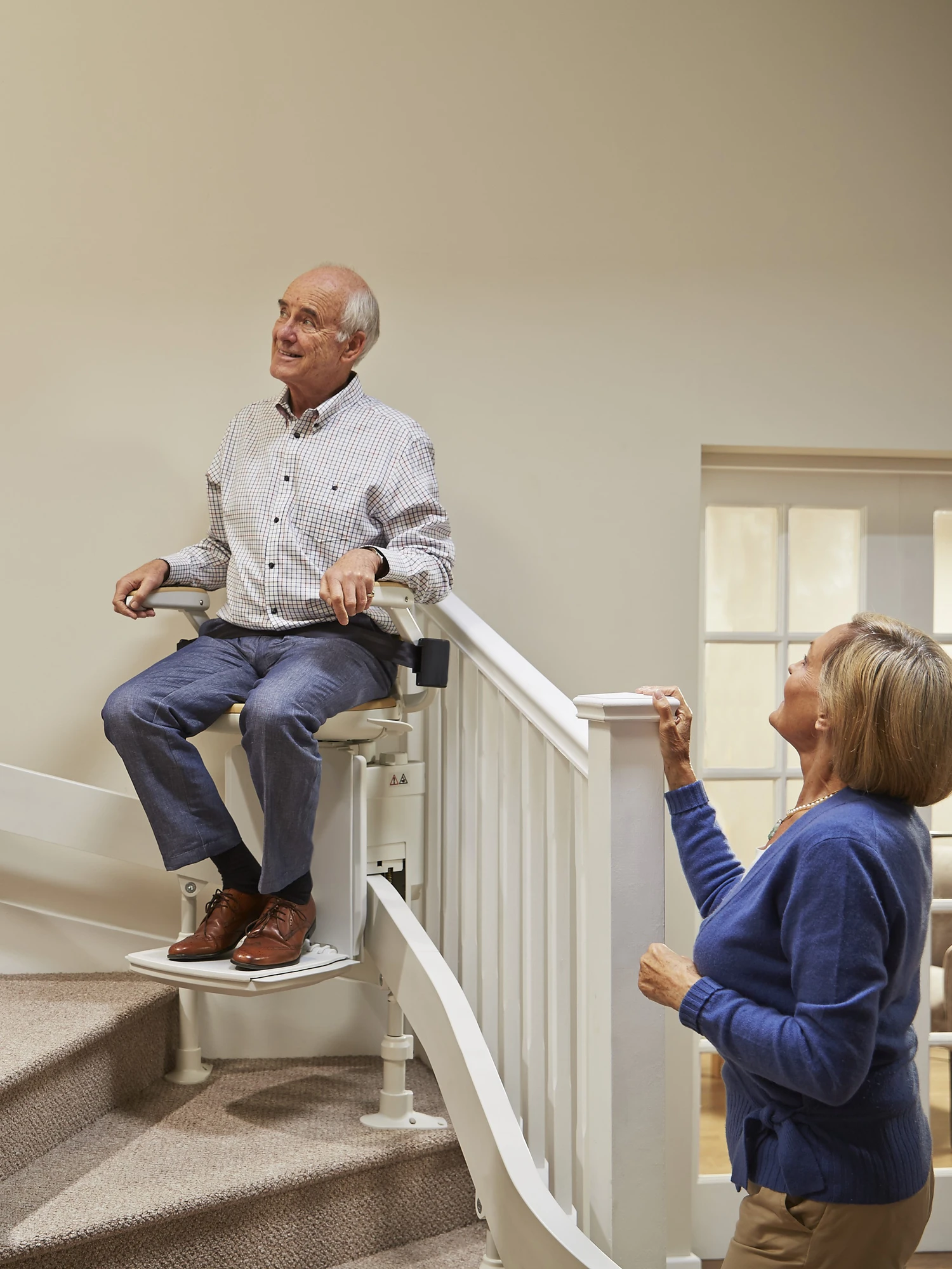 Curved Stairlift climbing stairs with people
